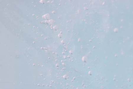 Abstract Blue ice background with air bubbles.の写真素材