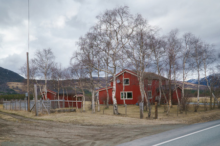 Norwegian spring landscape, Norway countryside. Classic wooden houses near mountains.の写真素材