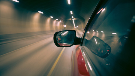 Road in tunnel. View from side of car. Motion blur shows the speed.の写真素材