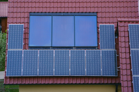 Solar panels on rood of modern resiadental house, renewable energy system.の写真素材