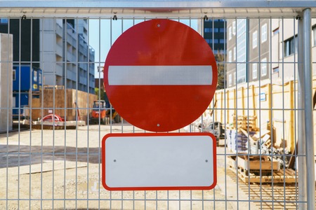 No entry sign on the fence in construction site of new apartment building in city, access is prohibited. Copy space for title.の写真素材