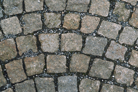 Old cobbled stone texture background, pavement structure on road.の写真素材