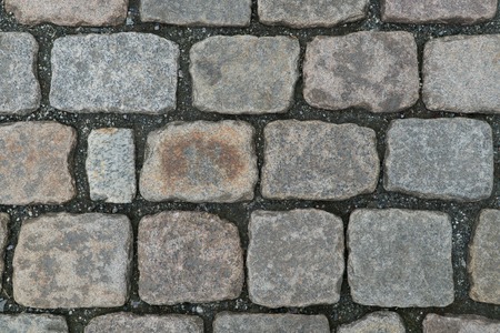 Old cobbled stone texture background, pavement structure on road.の写真素材