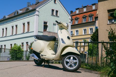 Vintage scooter on street of European city at bright sunny day, Regensburg, Germany.の写真素材