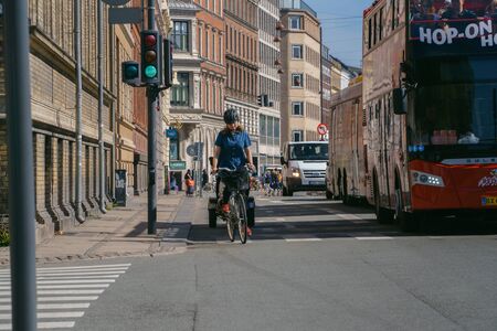 Copenhagen,Denmark - May 6, 2018: Woman riding bicycle on the streetのeditorial素材