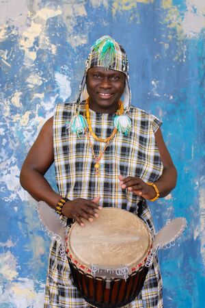 Portrait of handsome african musician with Djembe drumの写真素材