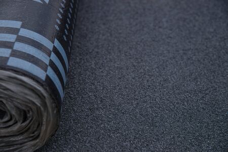 Waterproof bitumen roll covered with insulation materials, abstract background, closeup texture.の写真素材