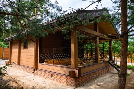 Small wooden cabin house near pine forest. Exterior designの写真素材