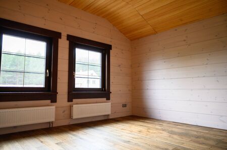 Empty room in a new wooden house, walls colored with natural paint .の写真素材