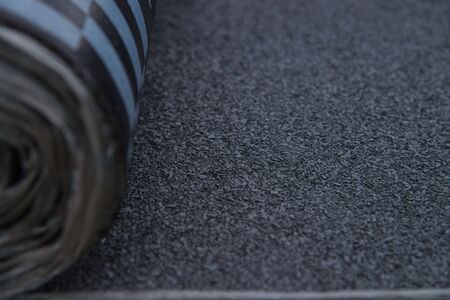 Waterproof bitumen roll covered with insulation materials, abstract background, closeup texture.の写真素材