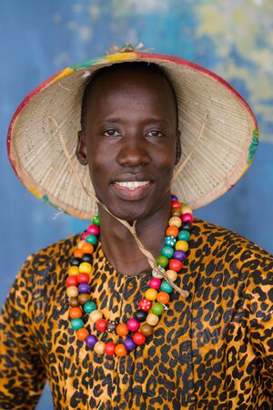 Closeup portrait of handsome african man in traditional Fulani hat and colorful clothesの写真素材