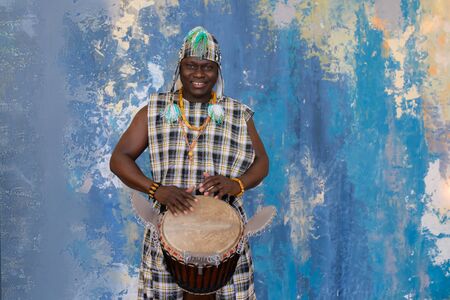 Portrait of handsome african musician with Djembe drumの写真素材