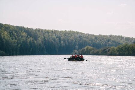 Team of people float down the River on inflatable catamaran.の写真素材