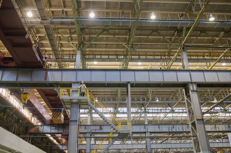 Izhevsk, Russia - December 14 2019: Automobile Factory AVTOVAZ background, engineer standing high and looking at working process on December 14, 2019 in Izhevskのeditorial素材