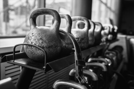 Kettlebells in a rack at the gym. Free weights close up