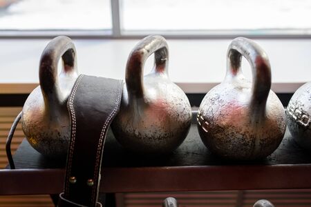 Kettlebells in a rack at the gym. Free weights close upの写真素材