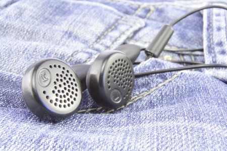 headphones on blue jeansの写真素材