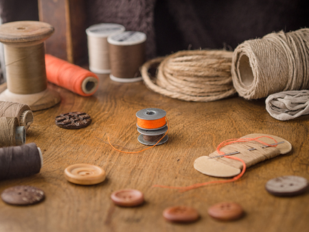 Vintage tools and accessories for sewing on wooden background