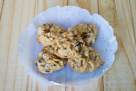 Nut cookies  on paper.,Chocolate cookies with paper on wooden background,cashew nut on wooden table.の写真素材