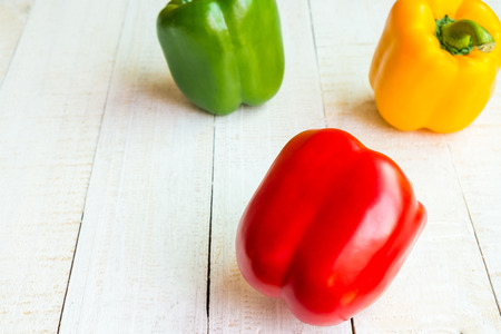 Sweet pepper on wooden background, multi color of sweet pepper that it is ingredient of food.の写真素材