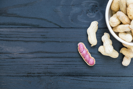 Peanuts in the bow on wooden backgroundの写真素材