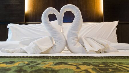 Towels decoration in bed room hotel., Heart is a symbol of love and romance.の写真素材