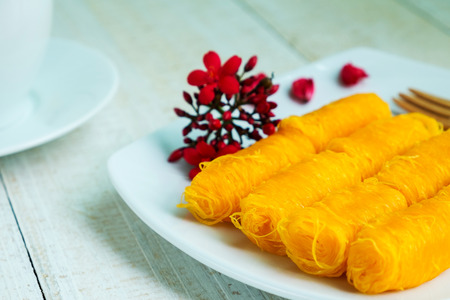 Golden Threads, Thai Traditional Dessert with tea on wooden