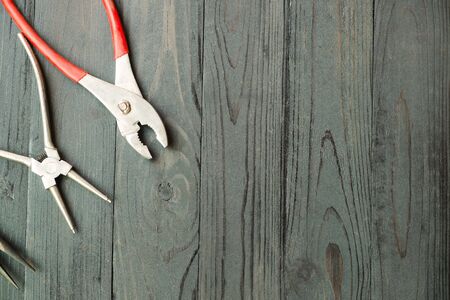 Pliers for remove the snap ring , Pliers on black woodの写真素材