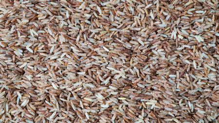 Brown rice background texture, Red rice background, Brown rice have Vitamin B2 , Brown rice is rich in Vitamin B2 helps prevent canker soreの写真素材