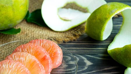Grapefruit on hemp , Fresh grapefruit and Grapefruit peel on black wood, Orange peel look like cellulite in the womenの写真素材