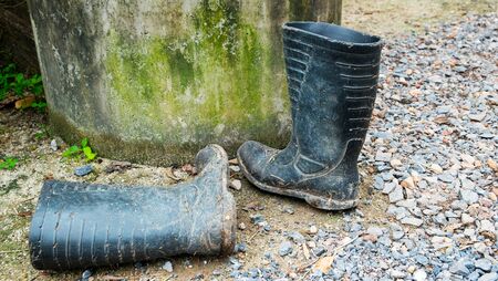 Dirty boots on the ground., Boots for the flood., abstract of difficultyの写真素材