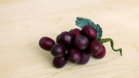 Grapes with leaf on wood backgroundの写真素材
