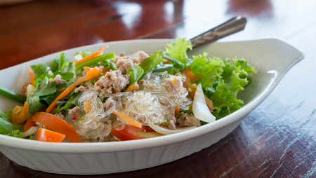 Pork Vermicelli Salad, Spicy vermicelli on white dishの写真素材