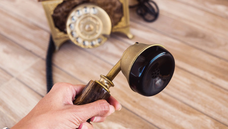 Antique telephone, Home telephone, Vintage telephone, abstract of communication, Hand holding the antique telephoneの写真素材