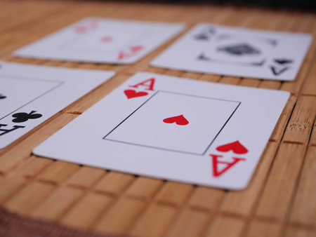 Casino theme. High contrast image of casino roulette, poker game, dice game, poker chips on a gaming table, all on colorful bokeh background.の写真素材