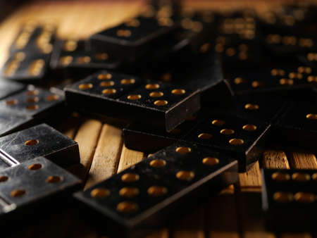 Black vintage dominoes on a black background, selective focus. WB photo.の写真素材