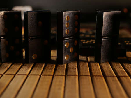 Black vintage dominoes on a black background, selective focus. WB photo.の写真素材