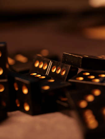 Black vintage dominoes on a black background, selective focus. WB photo.の写真素材