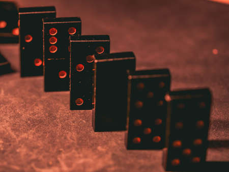 Black vintage dominoes on a black background, selective focus. WB photo.の写真素材