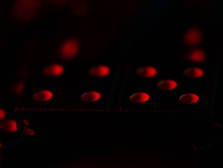 Black vintage dominoes on a black background, selective focus. WB photo.の写真素材