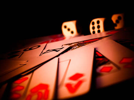 Dice and playing cards, black background