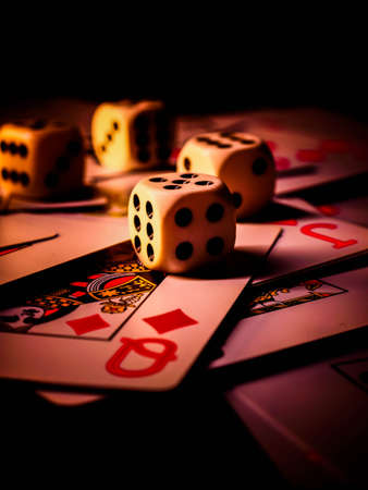 Dice and playing cards, black background