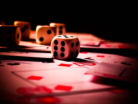 Dice and playing cards, black background