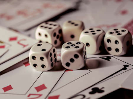 Dice and playing cards, black background