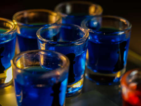 Chess board with shot glassesの写真素材