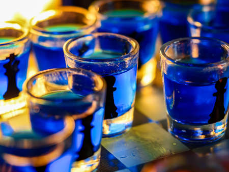 Chess board with shot glassesの写真素材
