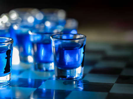 Chess board with shot glassesの写真素材