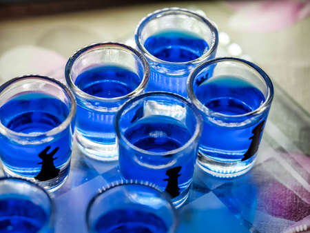 Chess board with shot glasses