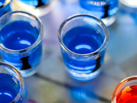 Chess board with shot glassesの写真素材