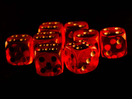 Red gambling dices on black backgroundの写真素材